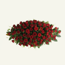 Birds eye view of red rose casket spray cover and foliage