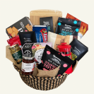 Close-up of Aroha Gift Basket with chocolates and savoury treats Aroha Gift Basket presented in a woven seagrass basket