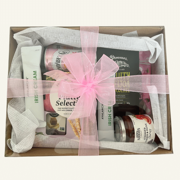 Manuka giftbox. A selection of NZ treats. Crackers, fruit paste, Donovans NZ chocolates, Chutney, Coffee sachets. All presented in a giftbox with clear lid & matching bow.