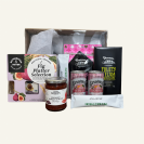Manuka giftbox. A selection of NZ treats. Crackers, fruit paste, Donovans NZ chocolates, Chutney, Coffee sachets. All presented in a giftbox with clear lid & matching bow.