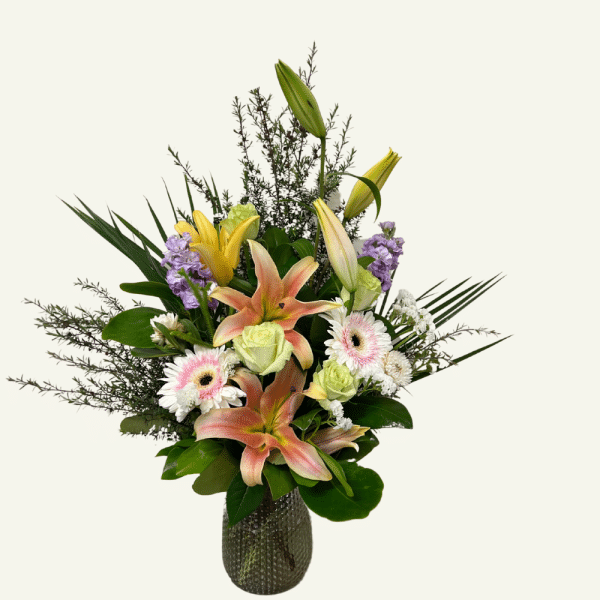 Floral vase arragement. Season fresh flowers & foliage arranged in a glass vase.