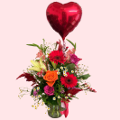Love bomb vase flower arrangement in glass vase & red heart shaped helium balloon.