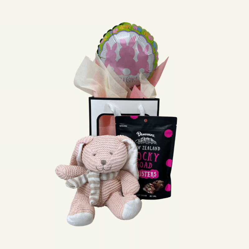 Easter Goodie Bag, treats and keepsake. Easter balloon, chocolates clusters, soft plush knitted bunny. Displayed in a window bag.