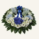 Anzac wreath with fresh foliage in blues & whites.