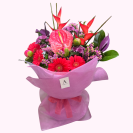 Berry Bliss bouquet with pink and red seasonal flowers wrapped in pastel pink paper by Amber Lee Florist Whangārei.